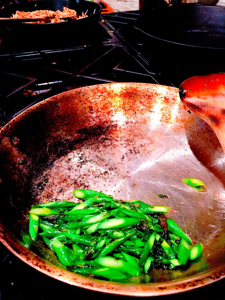 A Boulder home cook preparing Black Cat Farm asparagus — sauteed in olive oil with salt and a squeeze of lemon. Perfect.