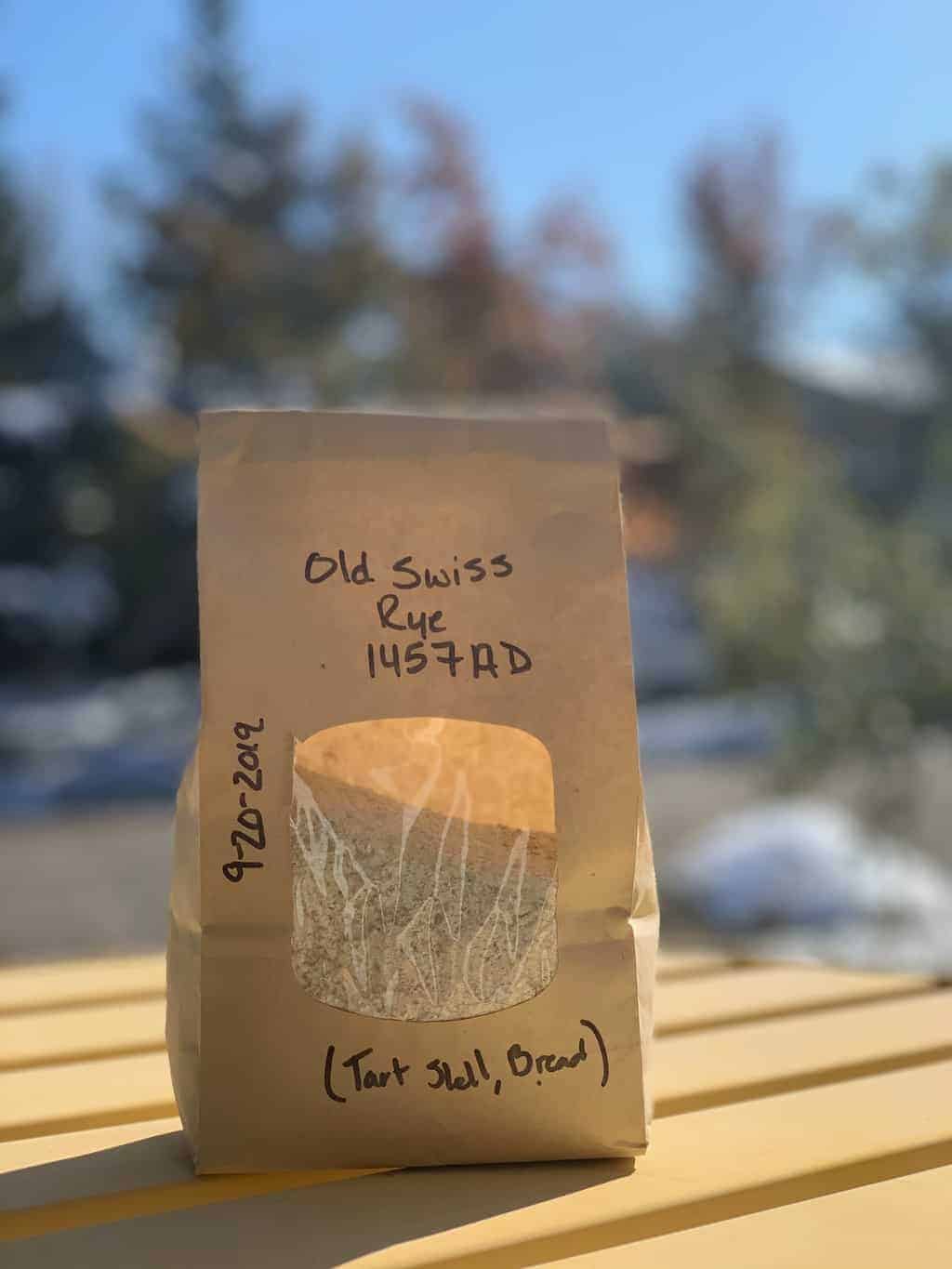 A bag of milled Wallis rye on a table, sold by Black Cat Organic Farm in Boulder, Colorado
