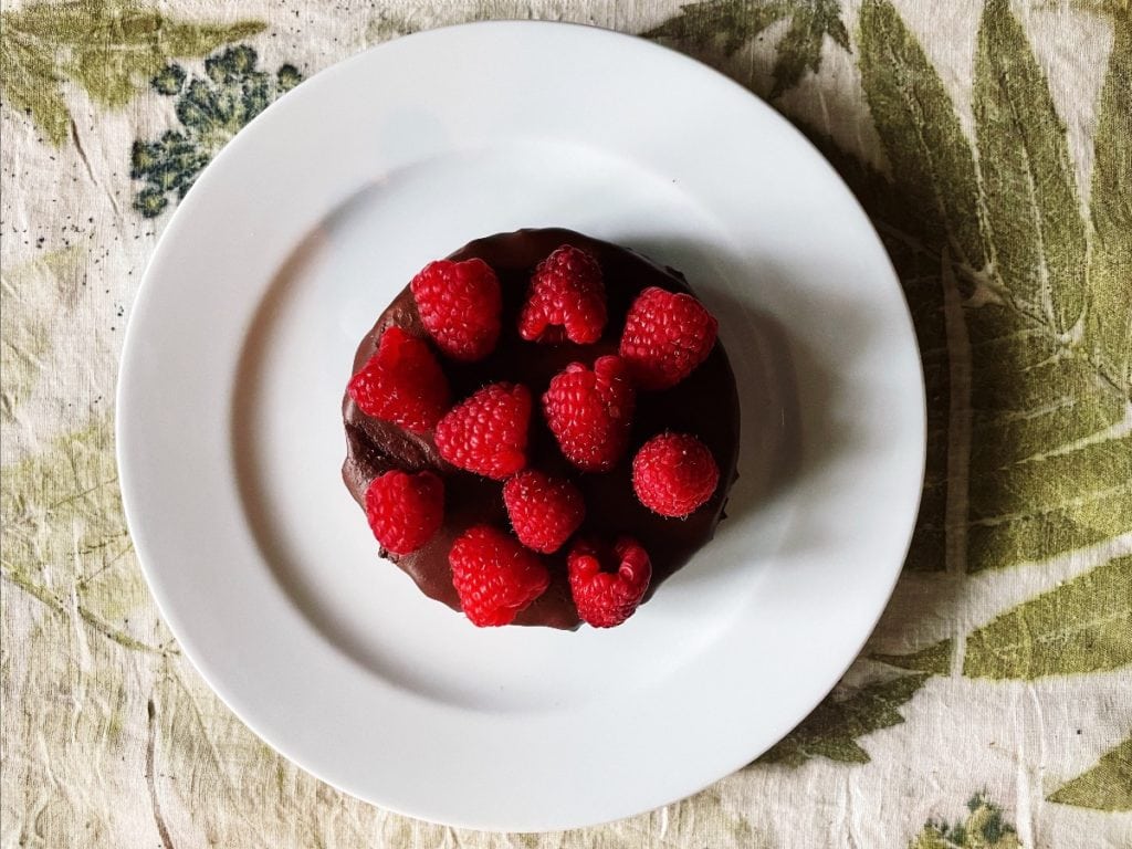 Black Cat Organic Farm Picture of Vegan Chocolate Cake with Raspberries.